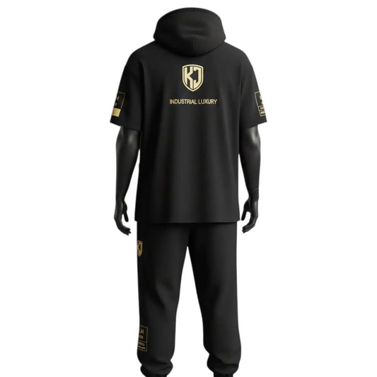 Back view of KJ Origin Drop premium short-sleeve hoodie set in heavyweight matte black fabric featuring gold-embossed KJ shield logo.
