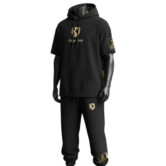 Front view of KJ Origin Drop premium short-sleeve hoodie set in heavyweight matte black fabric featuring gold-embossed KJ shield logo.