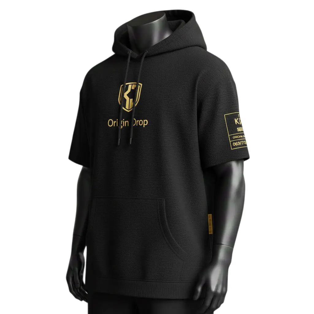 Front view of KJ Origin Drop premium short-sleeve hoodie in heavyweight matte black fabric featuring gold-embossed KJ shield logo.